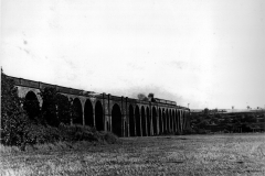 Awsworth_-_Viaduct_-_Locomotive__five_carriages_partway_across_the_viaduct_-_1950s