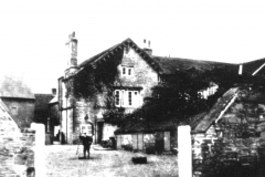 Broxtowe_-_Broxtowe_Hall_-_with_yard__Walter_Bramley_with_hay_rake_c1919