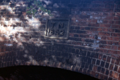 Cinderhill_-_plaque_on_railway_bridge_reading_T.N.1852_Bagnall_Road_1973.__Colour._Closer_to.